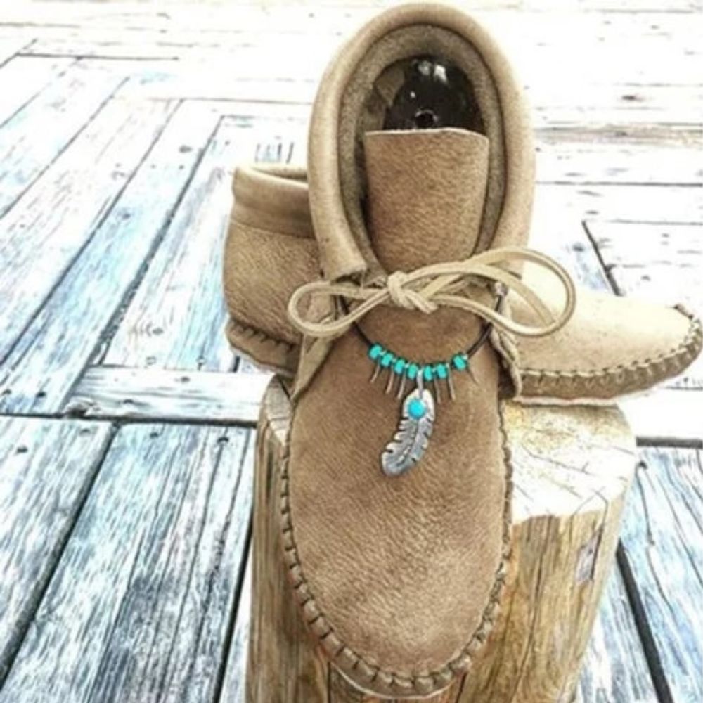 Mocassins indiens montants avec plumes décoratives