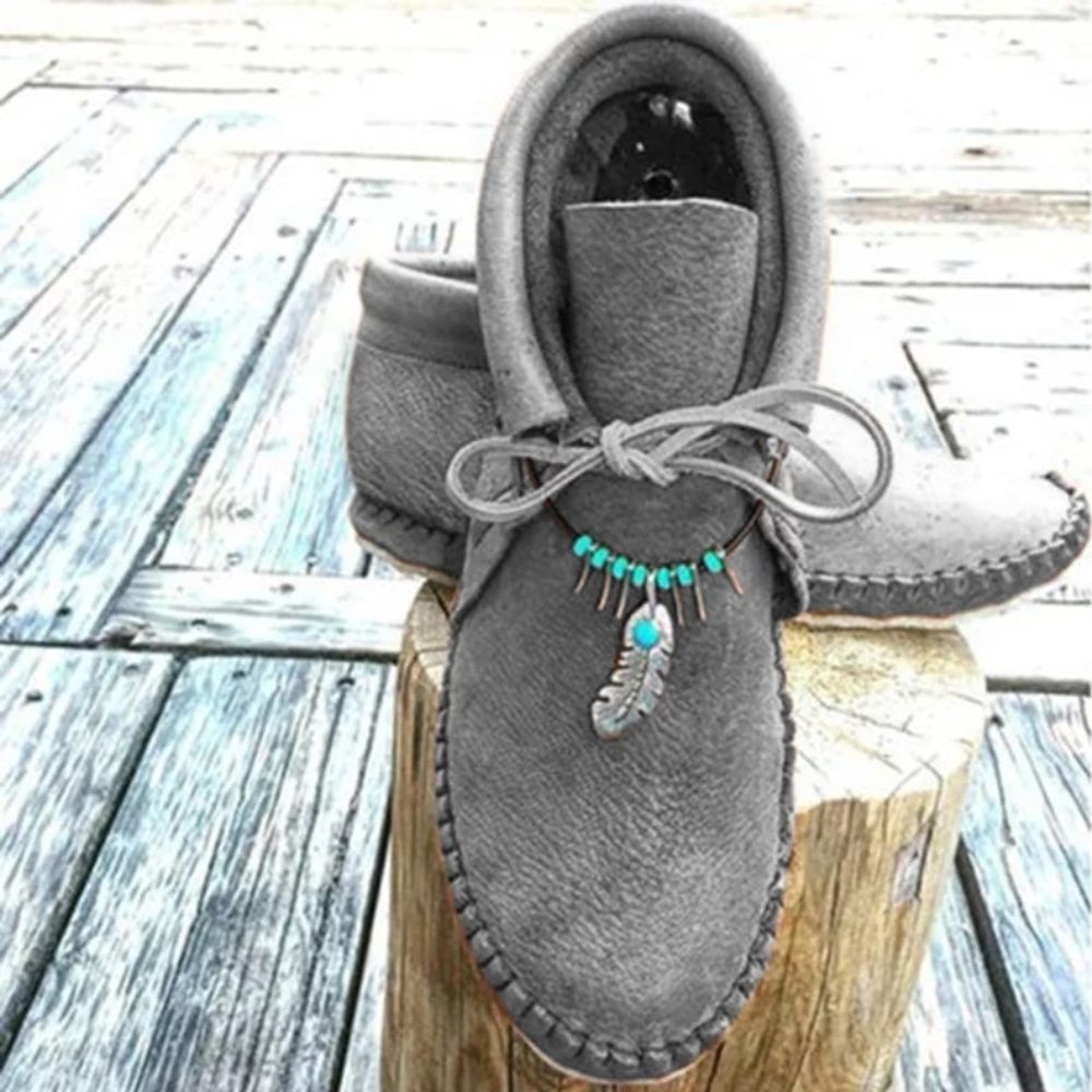 Mocassins indiens montants avec plumes décoratives