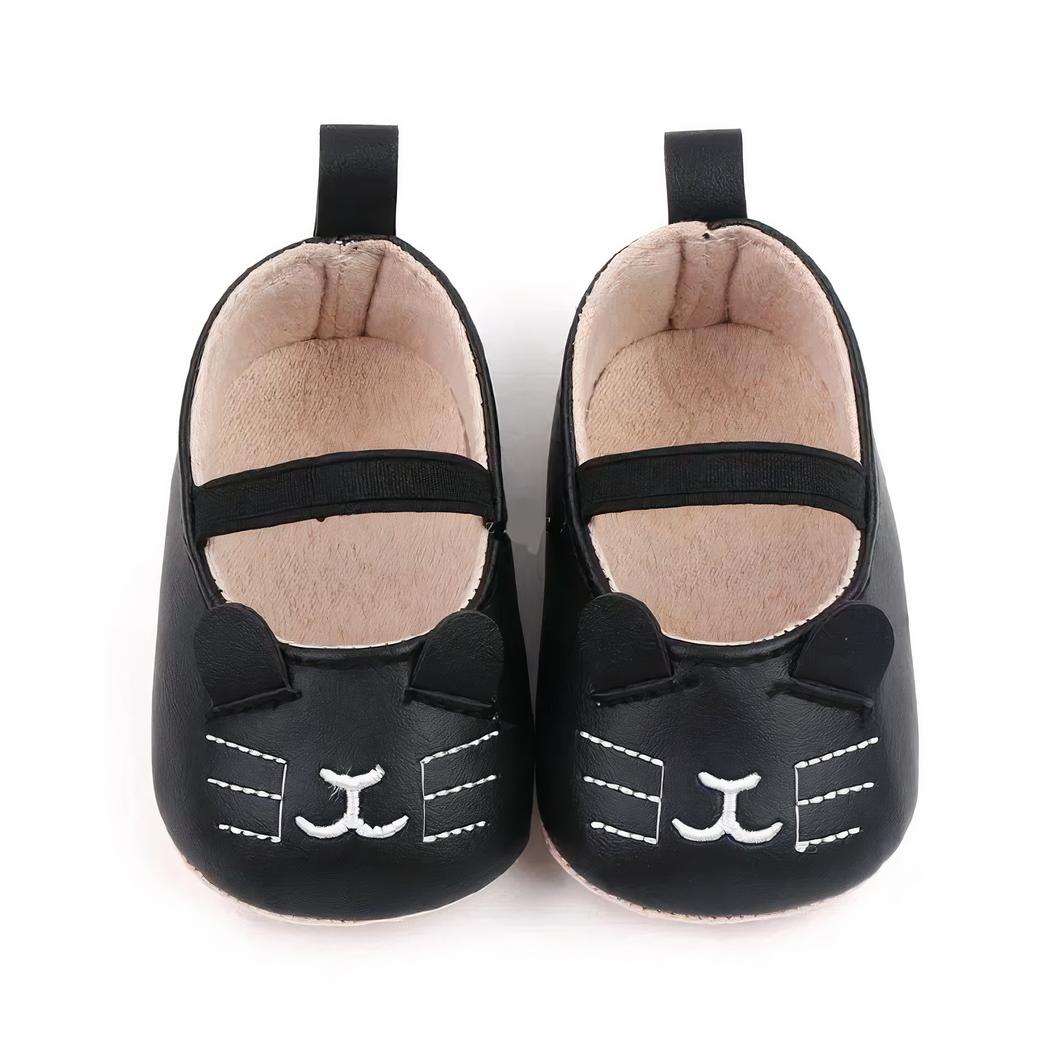 3 mocassins avec motif chaton pour bébé de couleur blanche, marron et noire alignés en diagonale sur fond blanc