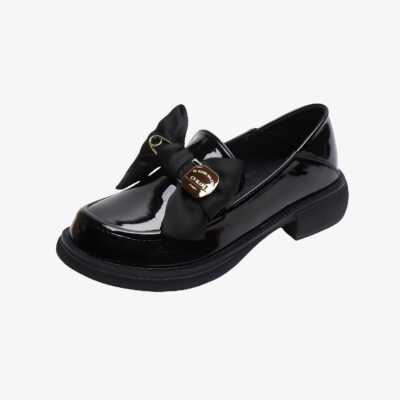 Mocassins à semelle épaisse à noeud papillon et épingle noir vernis sur fond gris très clair