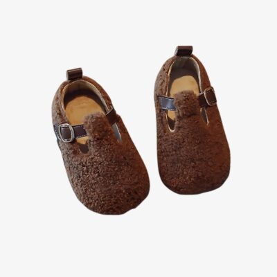 Mocassin en fausse fourrure pour fille sur fond gris clair.