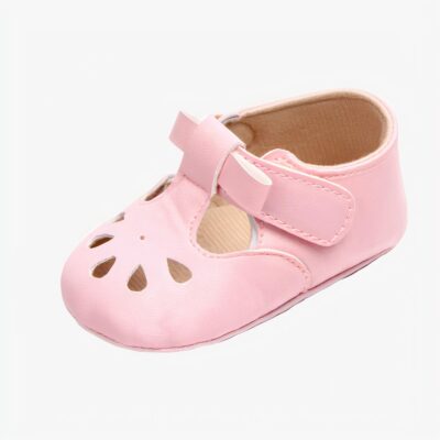 Mocassin rose avec une petite boucle et des petits trous au niveau des orteils sur fond blanc
