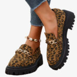 Paire de mocassins leopard en daim a plateforme avec une chaine, portees avec un jean et un bracelet de coquillage a la cheville
